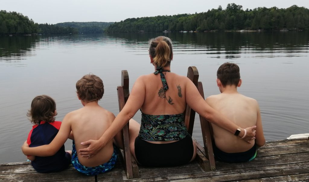 Featured Immage Mother and her boys, enjoying the view on a lake.