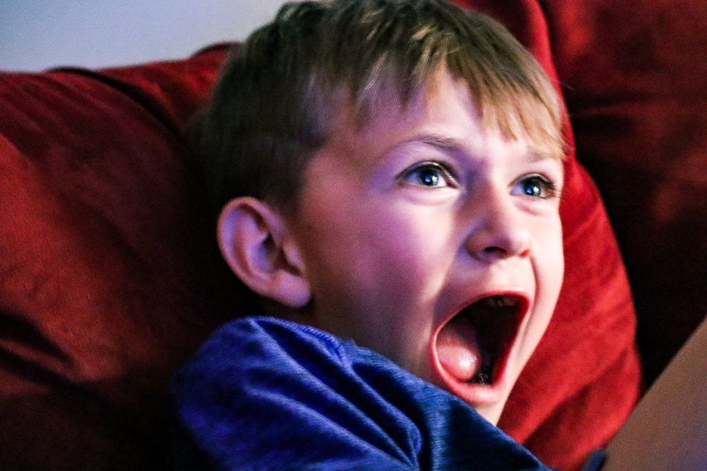 Yelling Boy in blue hoodie sitting on brown couch ©Lauren Bligh scop.io - Parenting A Child With ODD